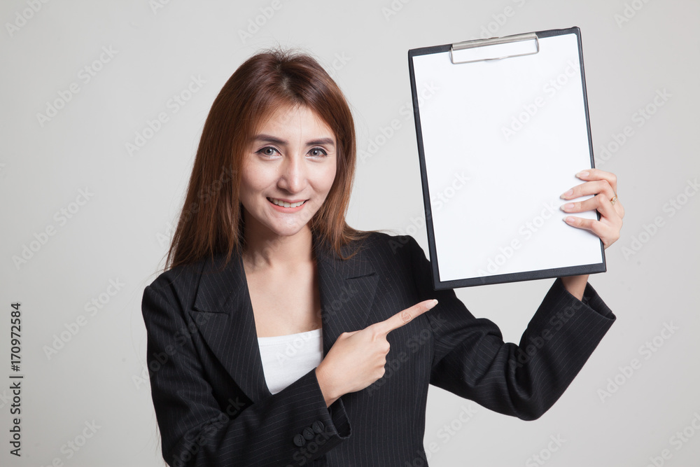 Young Asian business woman point to blank clipboard. Young Asian business woman point to blank clipboard.