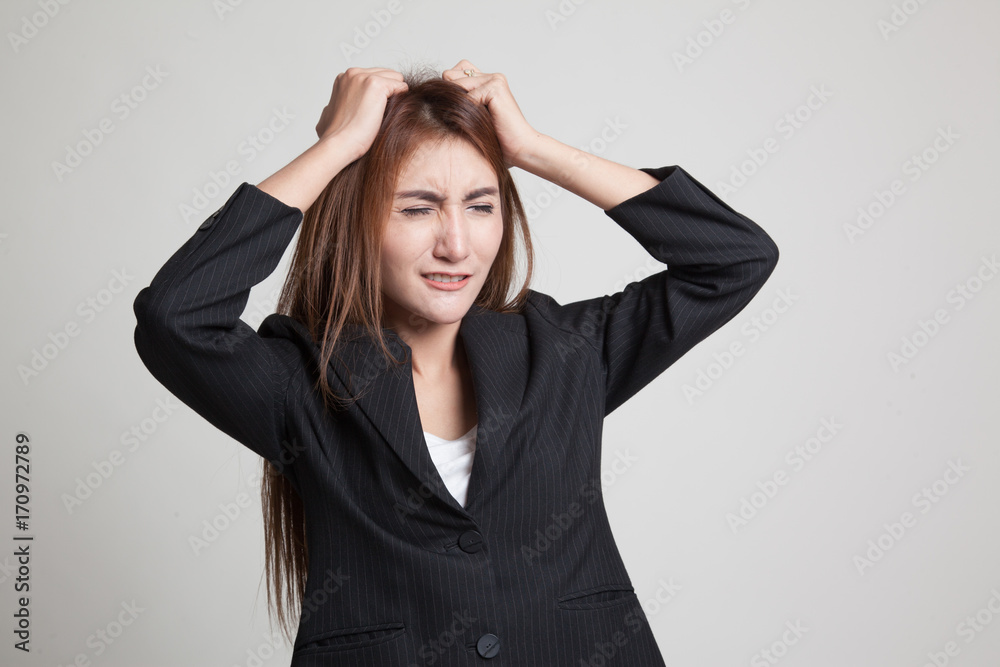 Stressed young Asian businesswoman scream out.