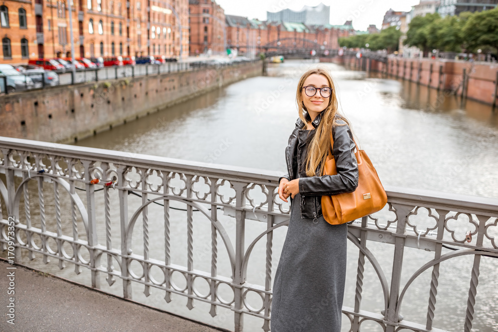 Lifestyle portrait of a stylish businesswoman on the old bridge in Hamburg, Germany