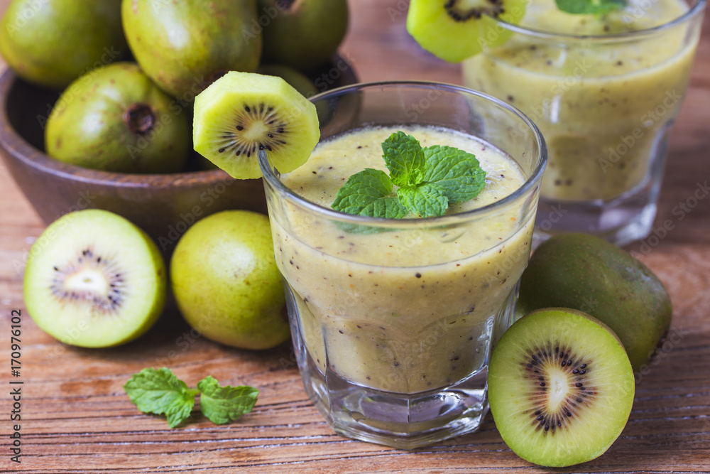 glass of kiwi juice with fresh fruits on wooden table glass of kiwi juice with fresh fruits on wooden table