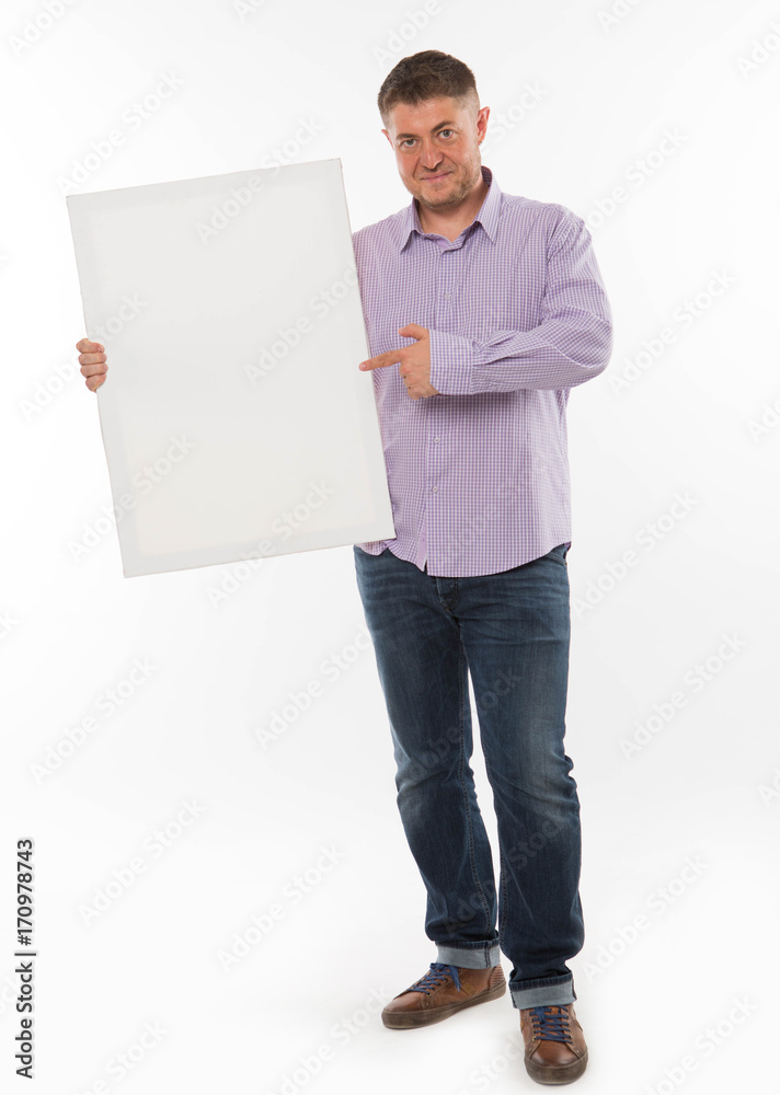 Young confident man portrait of a confident businessman showing presentation, pointing paper placard gray background. Ideal for banners, registration forms, presentation, landings, presenting concept. Young confident man portrait of a confident businessman showing presentation, pointing paper placard gray background. Ideal for banners, registration forms, presentation, landings, presenting concept.