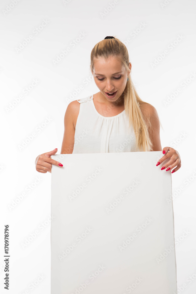 Young pry woman portrait of a confident businesswoman showing presentation, pointing placard gray background. Ideal for banners, registration forms, presentation, landings, presenting concept. Young pry woman portrait of a confident businesswoman showing presentation, pointing placard gray background. Ideal for banners, registration forms, presentation, landings, presenting concept.