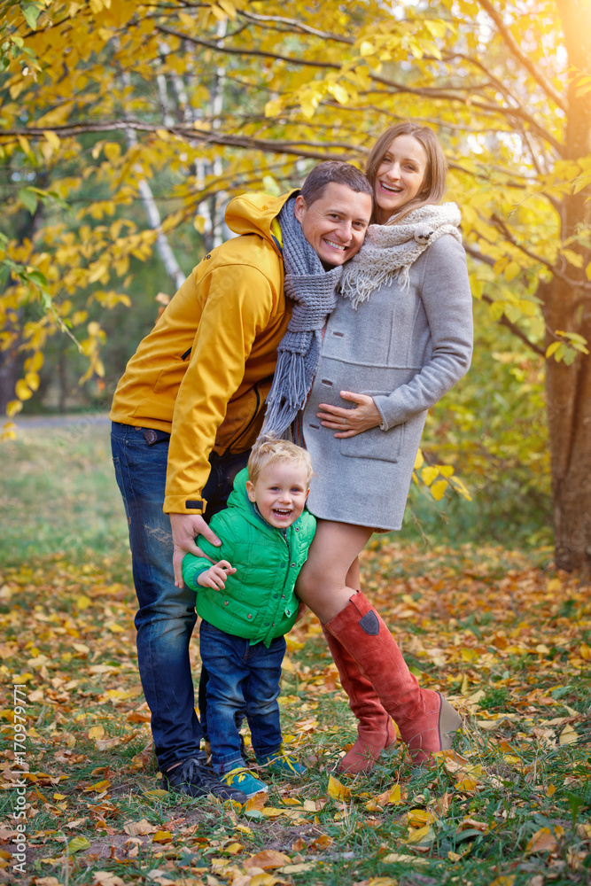 Happy family playing in autumn park Happy family playing in autumn park