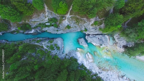AERIAL top down view: flight over mountain river Soca. Camera moves from top to down
