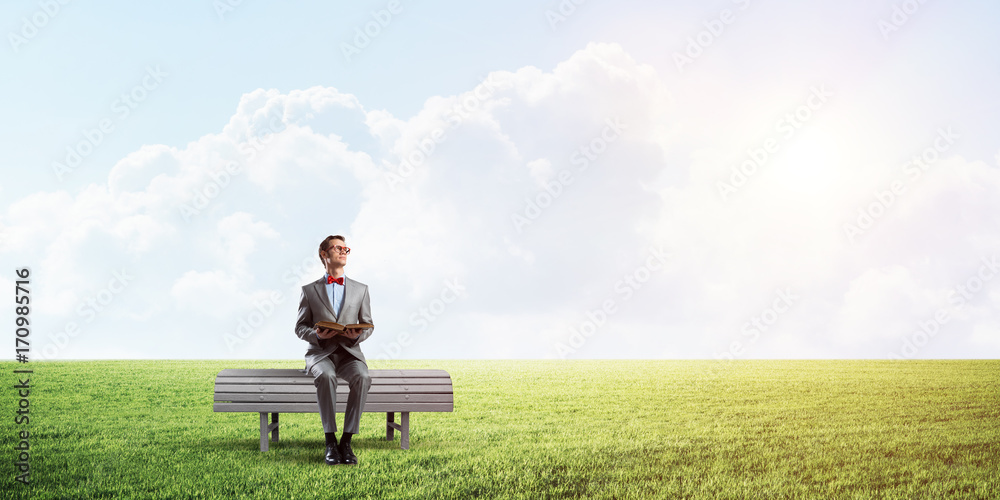 Young businessman or student studying the science in summer park Young businessman or student studying the science in summer park