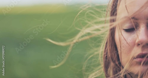 Close Up Portrait of Woman Standing on the Wind. SLOW MOTION 4K DCi. Breeze is playing with girls hair. Stormy weather, autumn, winter, spring. 