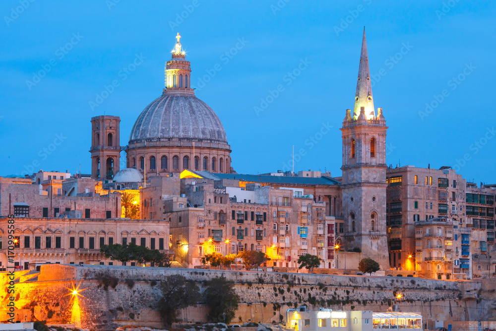 Valletta Skyline from Sliema with church of Our Lady of Mount Carmel and St. Paul's Anglican Pro-Cathedral during evening blue hour, Valletta, Capital city of Malta