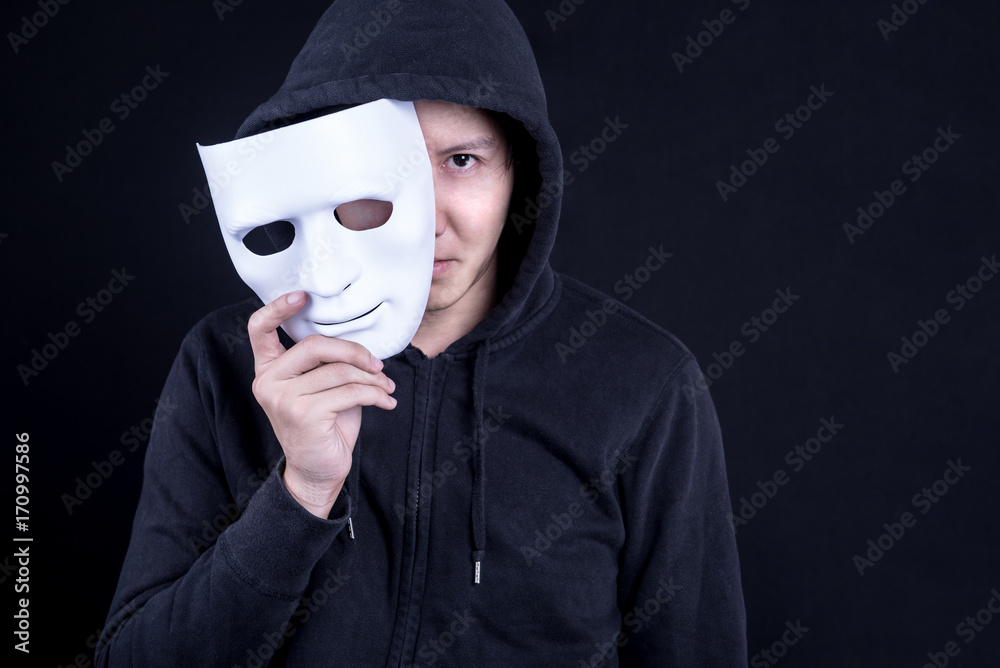 Fotografia do Stock: Mystery man holding white mask for hide his face.  Anonymous social masking or halloween concept. | Adobe Stock
