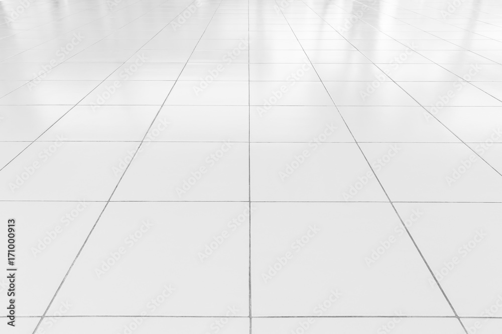 White tile floor background in perspective view. Clean, shiny, symmetry with grid line texture. For decoration in bathroom, kitchen and laundry room. And empty or copy space for product display also. White tile floor background in perspective view. Clean, shiny, symmetry with grid line texture. For decoration in bathroom, kitchen and laundry room. And empty or copy space for product display also.