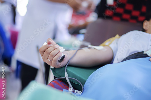 Blood donor at donation with a bouncy holding in hand