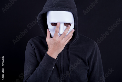Canvas-taulu Mystery man holding and wearing white mask for hide his face