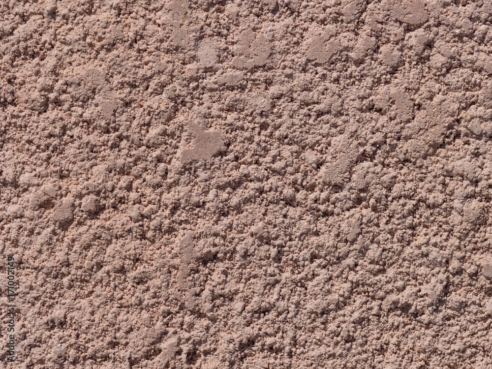 Fragment of the wall covered with coarse plaster of pink color Fragment of the wall covered with coarse plaster of pink color