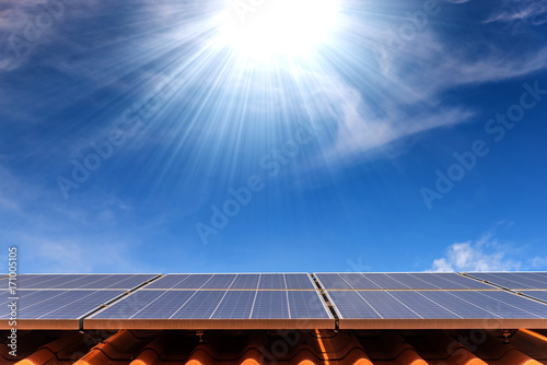solar cell panel on roof house with strong sun and sky