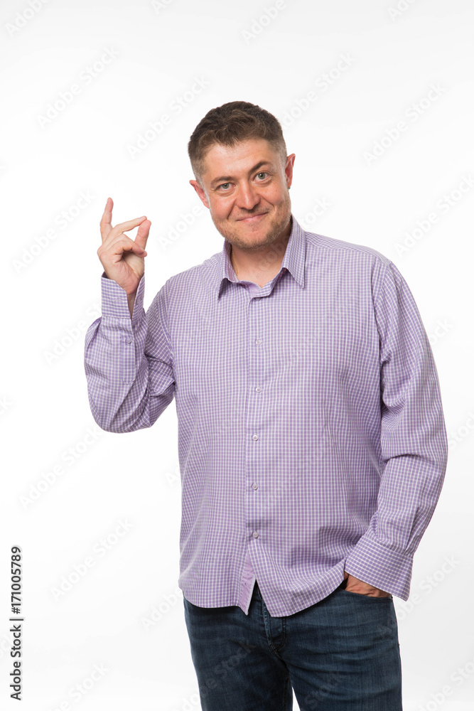 Young encouraged man portrait of a confident businessman showing by hands on a gray background. Ideal for banners, registration forms, presentation, landings, presenting concept. Young encouraged man portrait of a confident businessman showing by hands on a gray background. Ideal for banners, registration forms, presentation, landings, presenting concept.