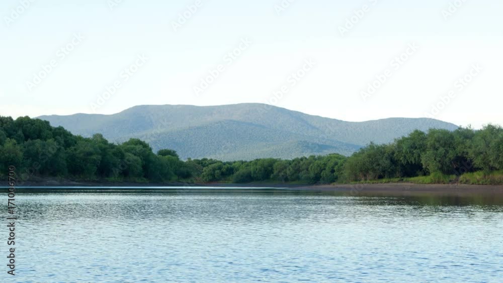 Mountain range Khekhtsir and the Amur river at dawn, timelapse. Mountain range Khekhtsir and the Amur river at dawn, timelapse.