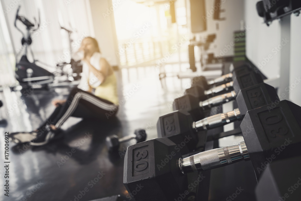 Fitness woman drinking water after work out