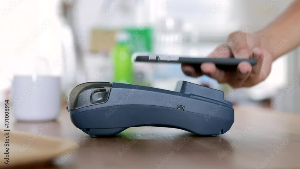 Using pos Terminal with cellphone at shop Using pos Terminal with cellphone at shop