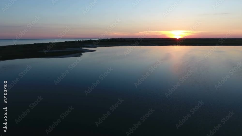Impressive view of a magical sunset over the splendid Black Sea coast from a bird`s eye perspective on a sunny day in summer. The calm sea is dark blue and violet a bit Impressive view of a magical sunset over the splendid Black Sea coast from a bird`s eye perspective on a sunny day in summer. The calm sea is dark blue and violet a bit