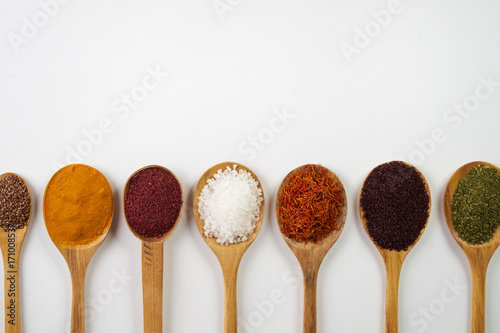 Variety of indian spices and herbs isolated on white