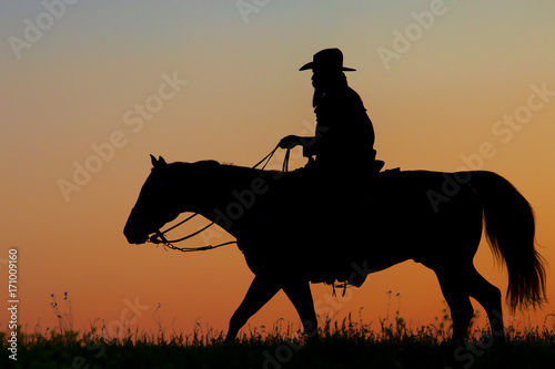 Silhouette of a Cowboy riding his horse