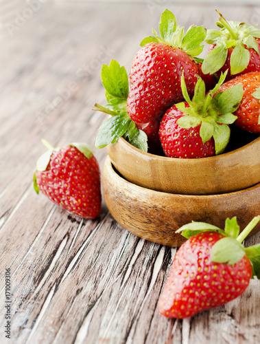 Fresh strawberries in a wooden bowl  selective focus