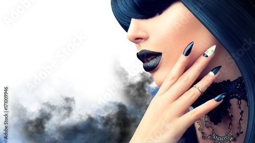 Fashion Halloween model girl with trendy gothic black hairstyle, makeup and manicure