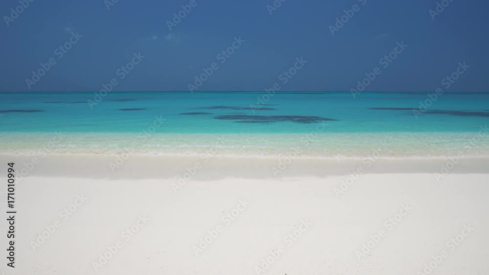 Tropical sandy beach with calm waves. Maldivian destination with nobody Tropical sandy beach with calm waves. Maldivian destination with nobody