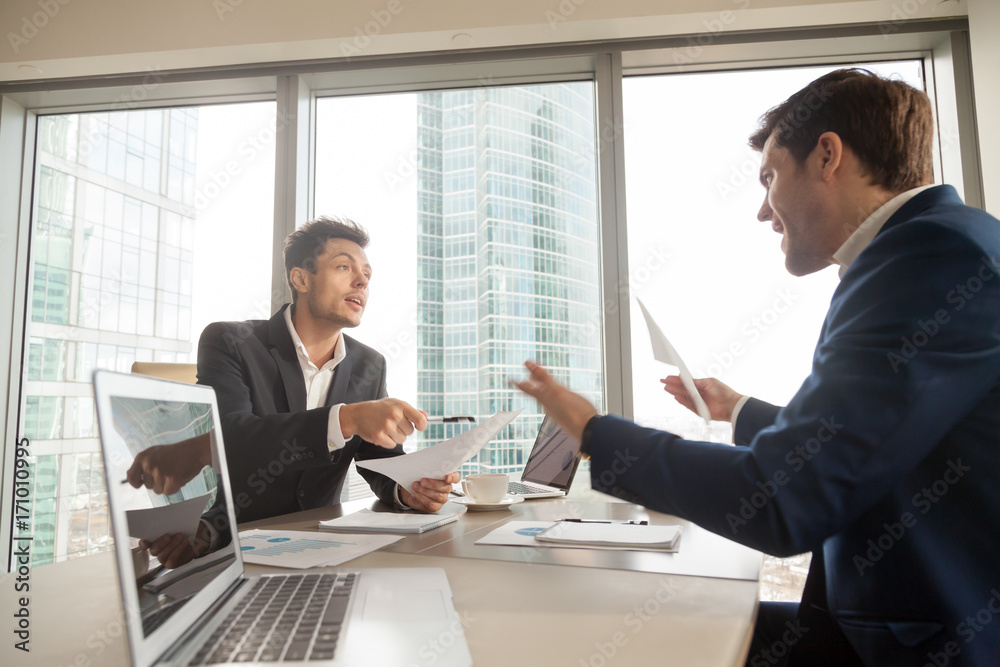 Two company leaders intensely discussing or arguing because of contract terms, can not come to agreement during negotiation, disagree with colleague opinion about business results. Dissatisfied client Two company leaders intensely discussing or arguing because of contract terms, can not come to agreement during negotiation, disagree with colleague opinion about business results. Dissatisfied client