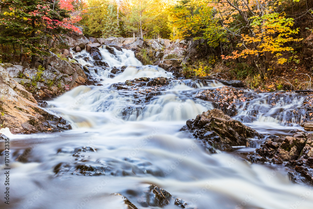 Waterfall on a creek through the wood in Canada, long exposure Waterfall on a creek through the wood in Canada, long exposure