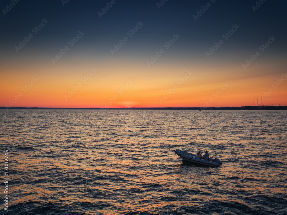 Aerial view over Fishing boat on the water and beautiful sunset.