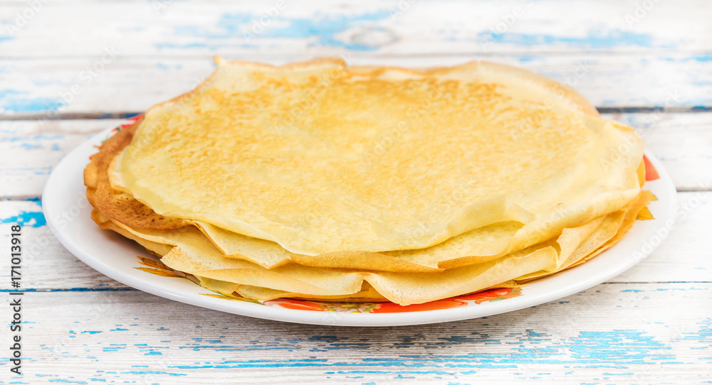 Plate with pancakes on the old blue table. Plate with pancakes on the old blue table.