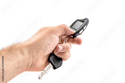 man's hand holding car remote control with screen. Isolated on white.