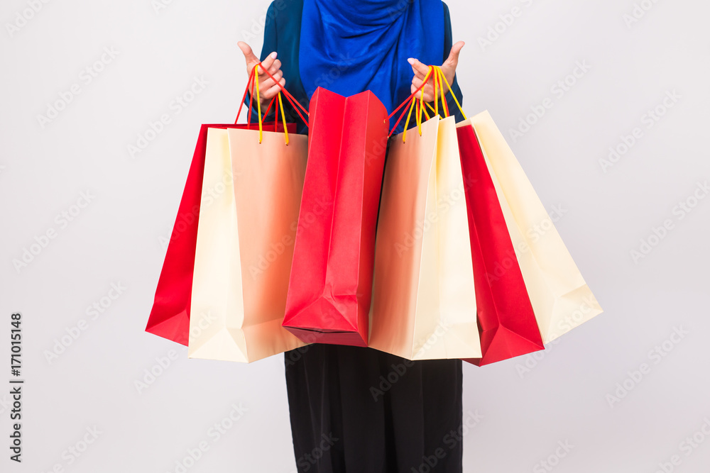 Close up of muslim woman with shopping bag on white background