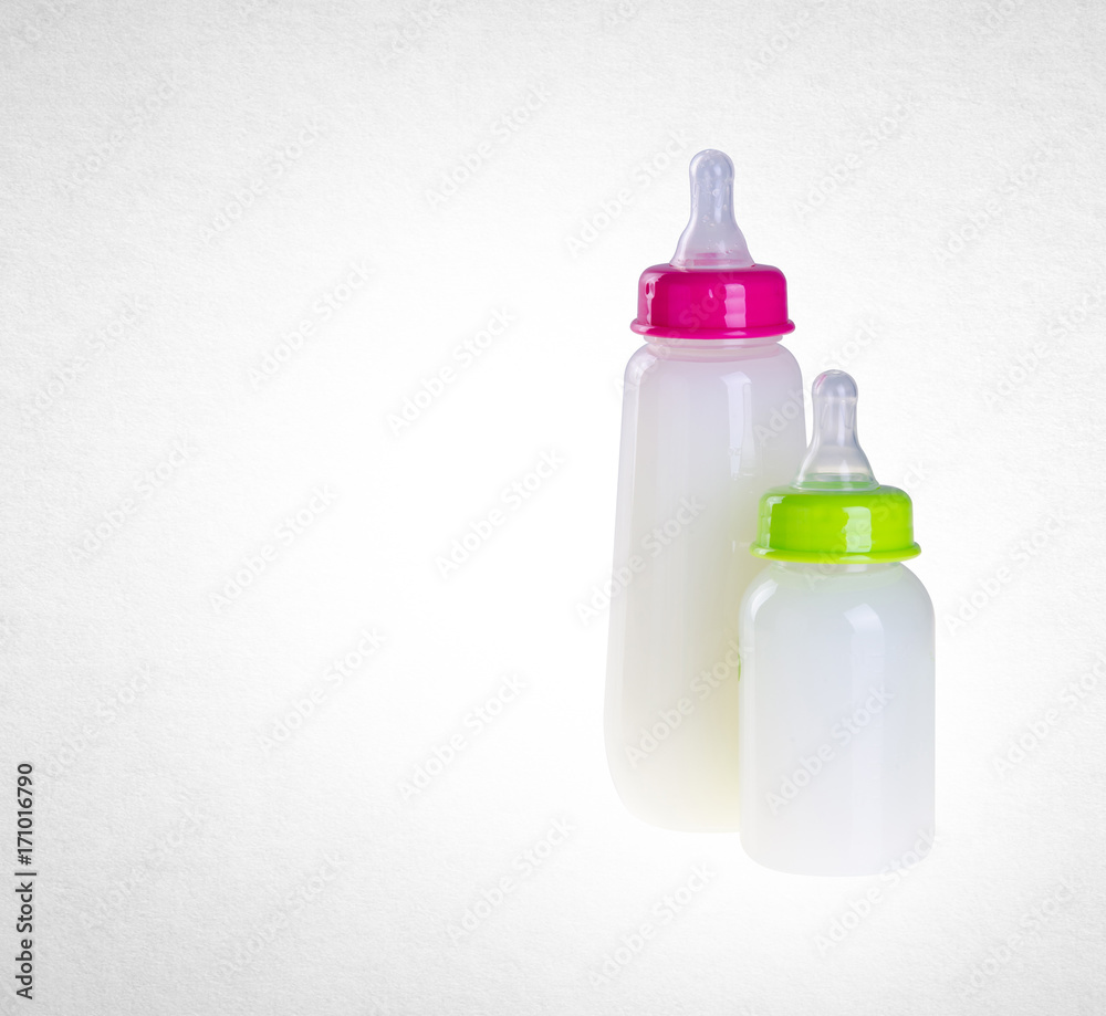 Baby bottle with milk on background Baby bottle with milk on background