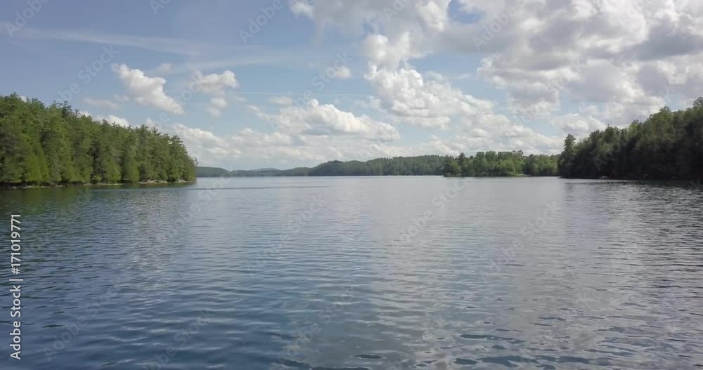 Aerial flying down a channel of a lake on a semi cloudy day Aerial flying down a channel of a lake on a semi cloudy day