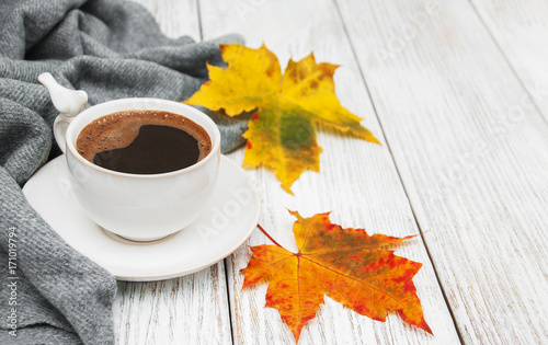 Cup of coffee and autumn leaves