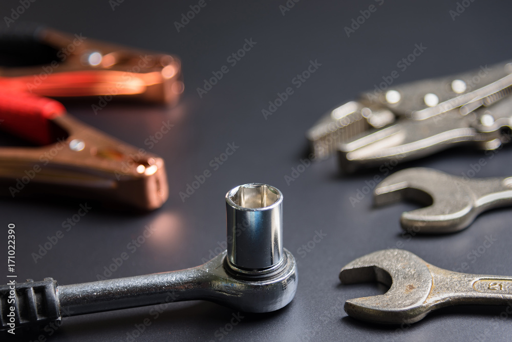 Car repair tools on the black background.selective focus. Car repair tools on the black background.selective focus.