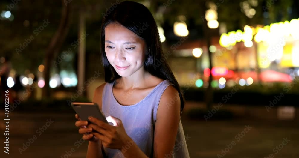 Asian woman use of cellphone at night Asian woman use of cellphone at night