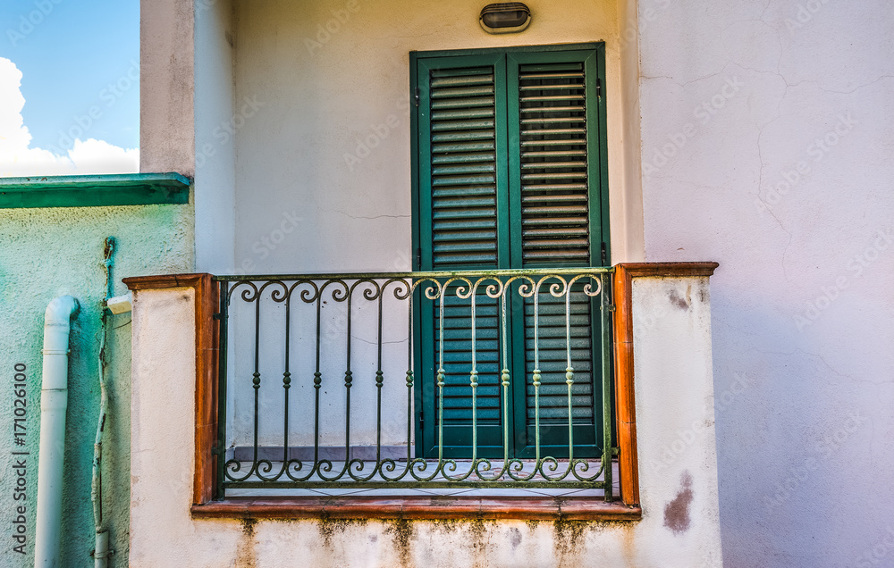 Small balcony and green shutters