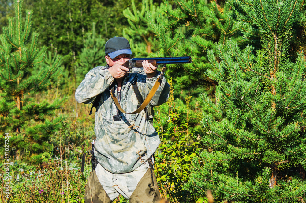 Naklejka premium Hunter on the hunt in late summer