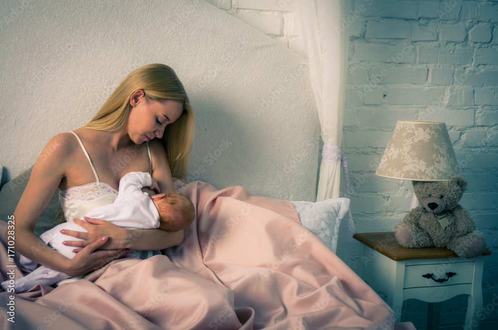 Breastfeeding baby. Mother nursing her child. Newborn eat breast milk.