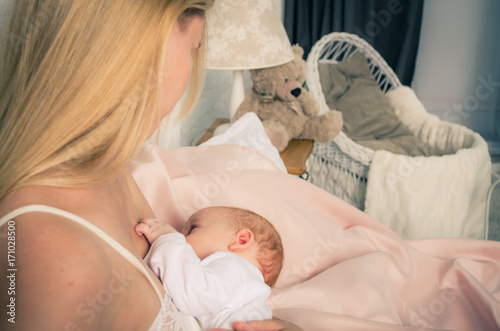Breastfeeding baby. Mother nursing her child. Newborn eat breast milk.