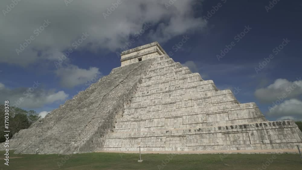 CHICHEN ITZA, MEXICO - MAY 25, 2017: Clouds move above Maya pyramid temple of Kukulkan in Mexico CHICHEN ITZA, MEXICO - MAY 25, 2017: Clouds move above Maya pyramid temple of Kukulkan in Mexico