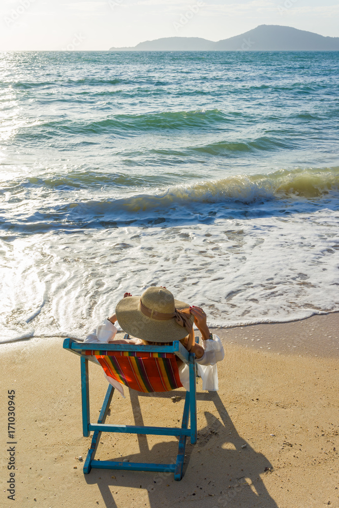 woman relaxing on sun bed sofa lounge chair on holidays woman relaxing on sun bed sofa lounge chair on holidays