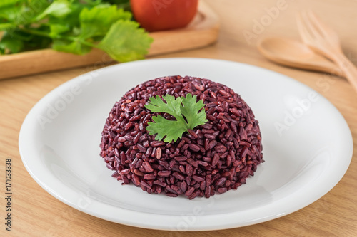 Black rice cooked on white plate