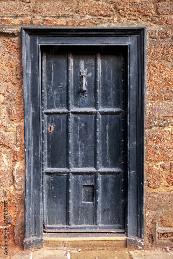 old wooden door with vintage rustic knocker knob, Exeter, UK, February 18, 2017