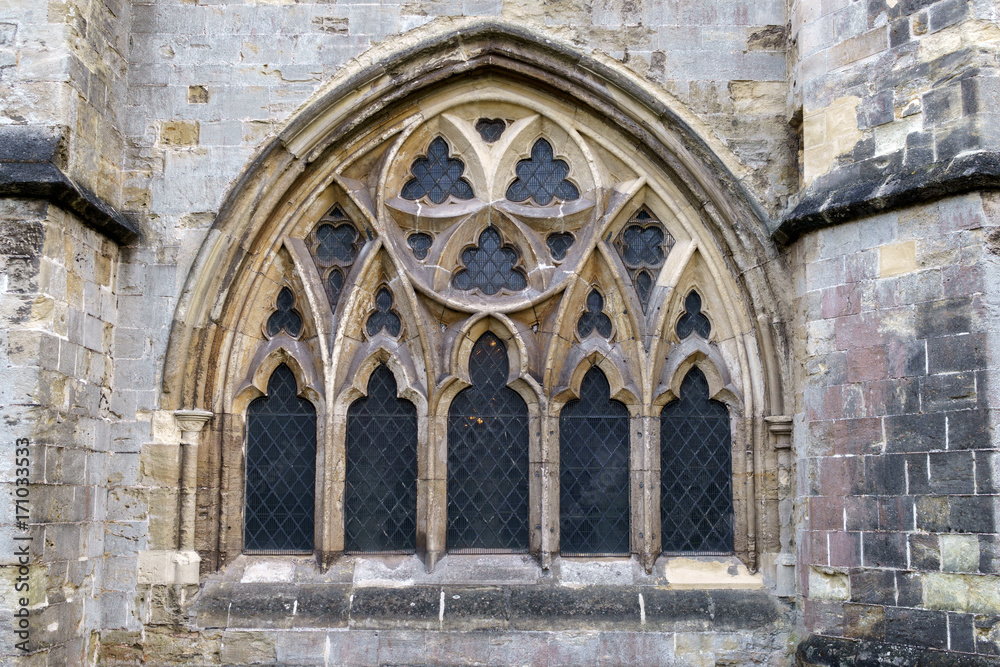Exterior view of stained-glass gothic window with tracery of cut stone in the Cathedral Church of St Peter in Exeter, February 18, 2017