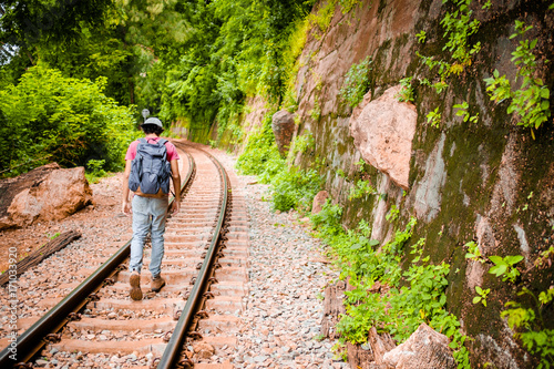 man traveling walking with backpack at national park in the jungle day time sun shine on holiday at weekend relax fresh on background nature view