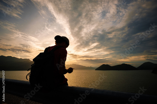 man traveling walking with backpack at national park in the jungle day time sun shine on holiday at weekend relax fresh on background nature view