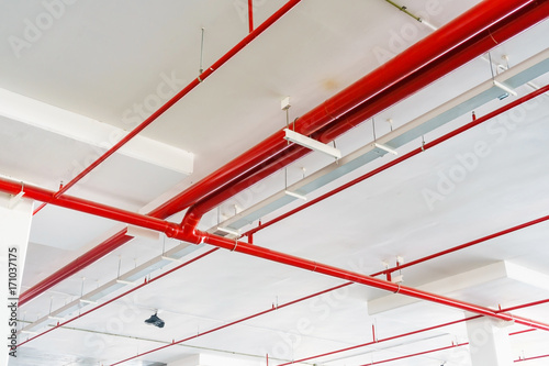 red pipeline extinguishing water in industrial building